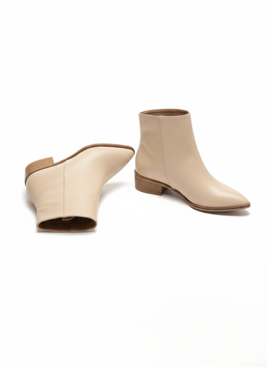 Bej of beige ankle boots on a white background