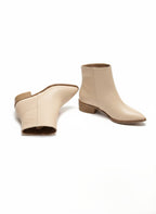 Bej of beige ankle boots on a white background